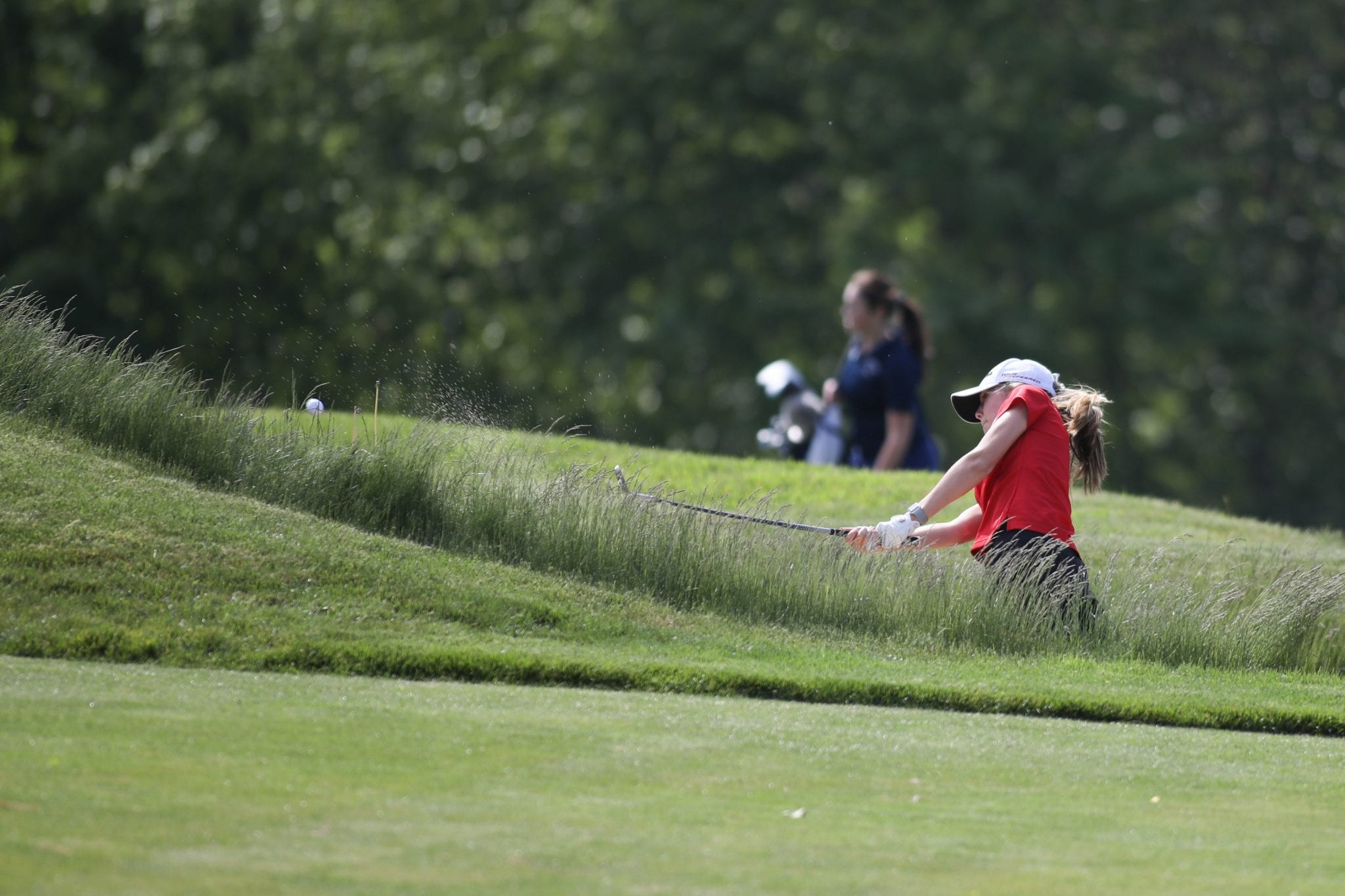 Senior Sarah Dansreau with a nice chip out of the bunker on the first hole. 