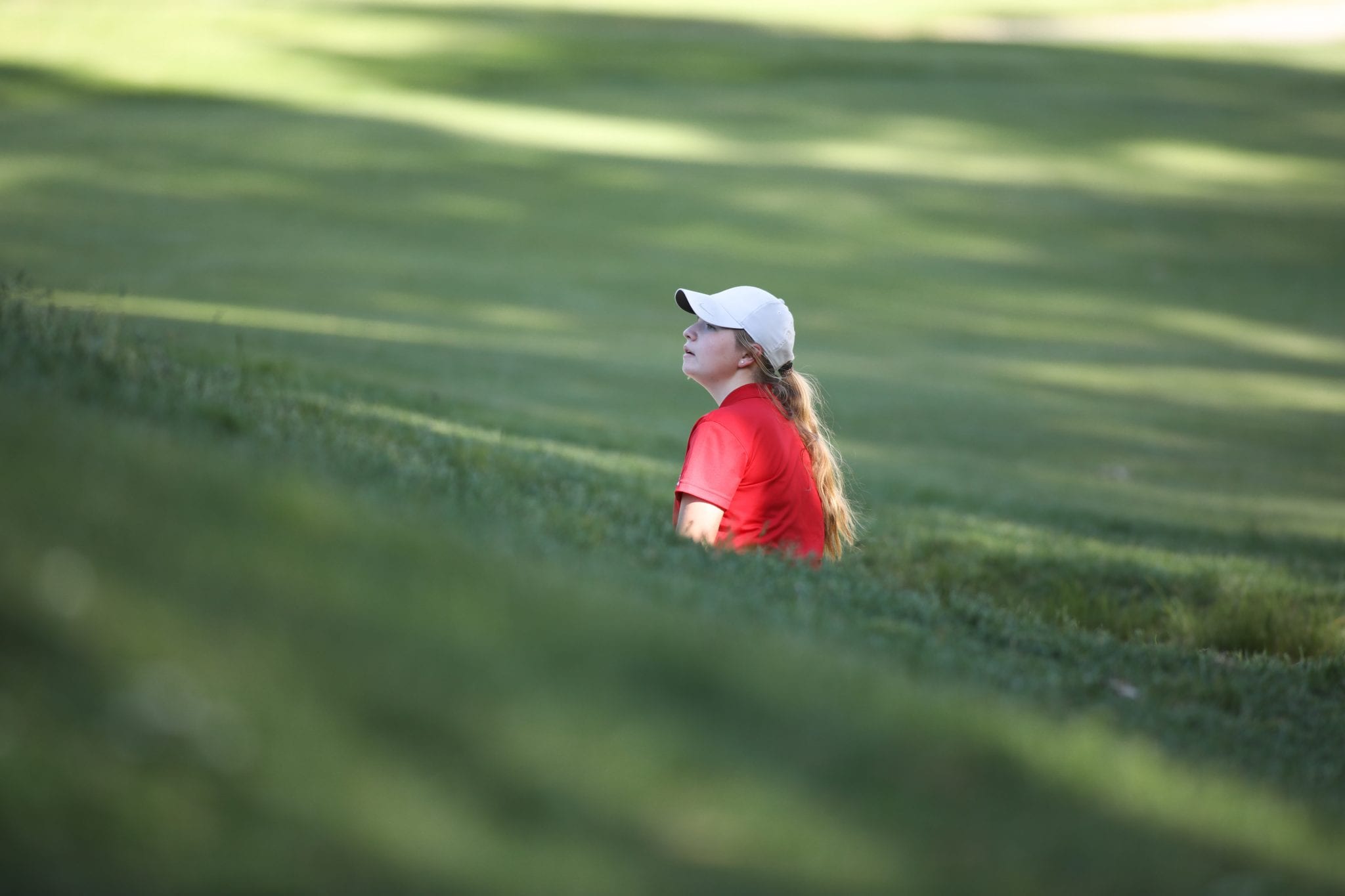 Sophomore Piper Jordan checks out where the pin is from the bunker well below the hole.  