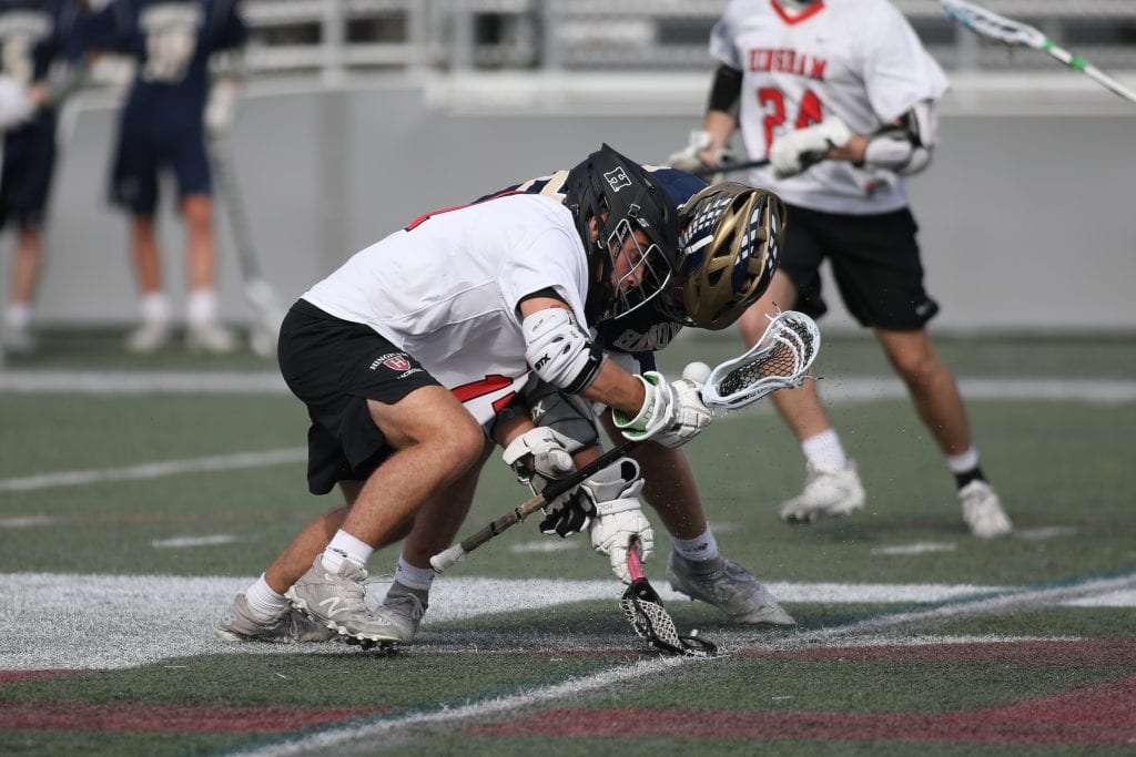 Junior Luke St. Pierre battles for a face-off win in the first quarter.