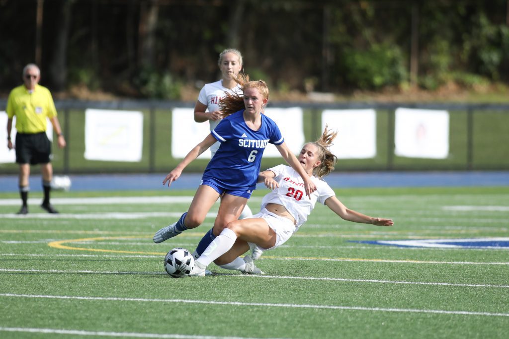 Sophomore Ava Varholak slides to kick the ball away from Scituate's Lindsay Hausmann