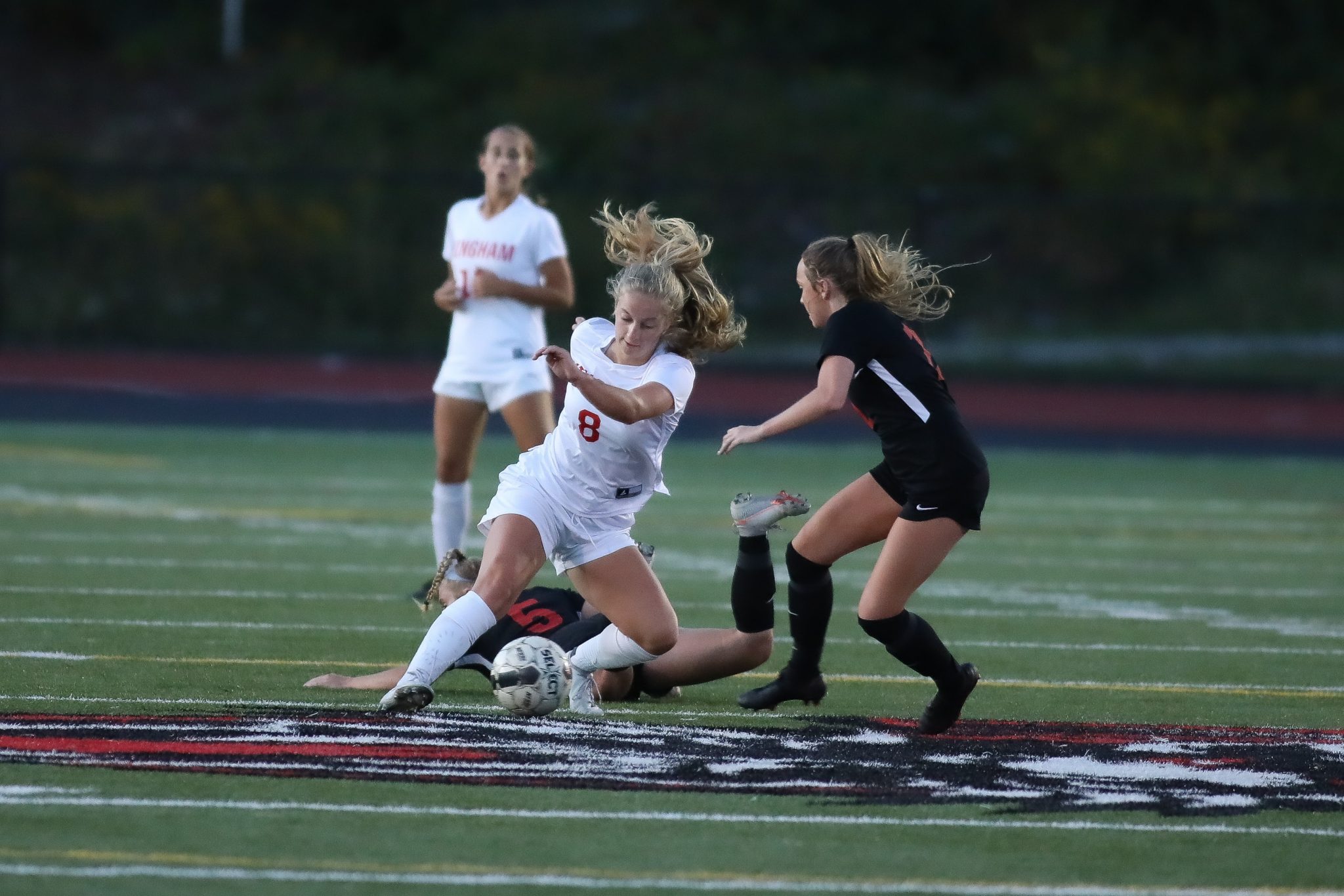 Junior Sophie Reale dribbles past a few Whitman-Hanson defenders in Monday's draw.  