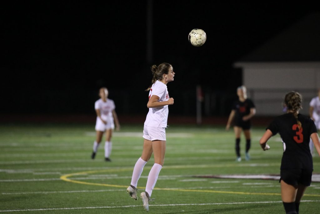 Junior Emily Gibbons also uses her head in getting the ball to her teammates. 