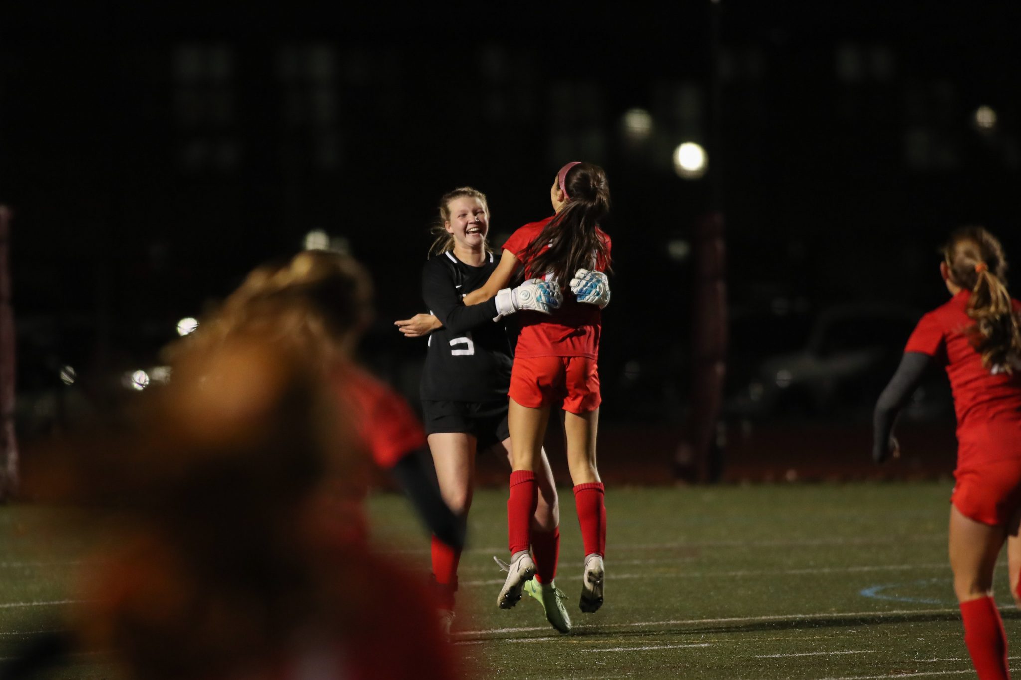 Sophomore Reese Pompeo jumps into the arms of senior goaltender Kathryn Wilson as the final whistle blows, sending the girls to the state finals!