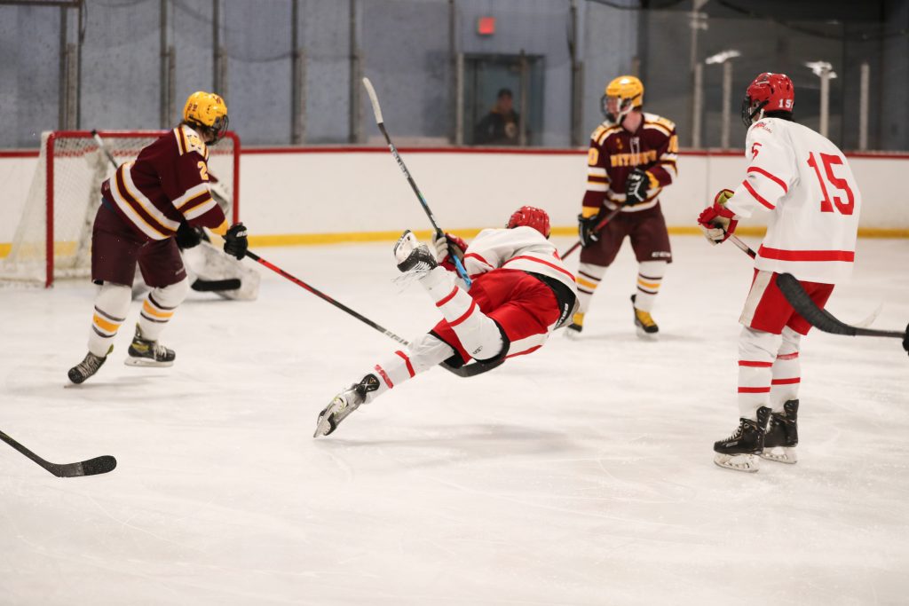 Senior captain Bobby Falvey lays out for a shot in the third period.