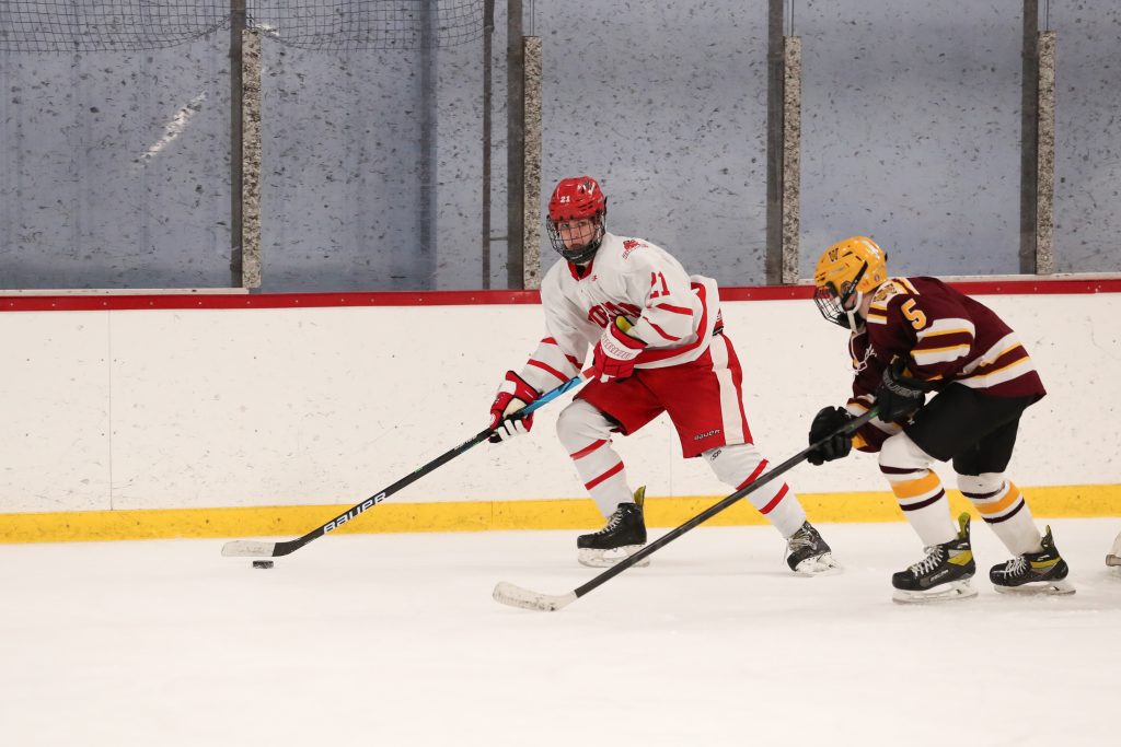 Sophomore Michael Garrity carries the puck deep in the Weymouth zone. 