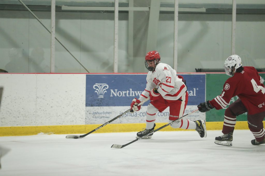 Junior Ace Concannon takes the puck up the boards around a defender in the opening minutes.