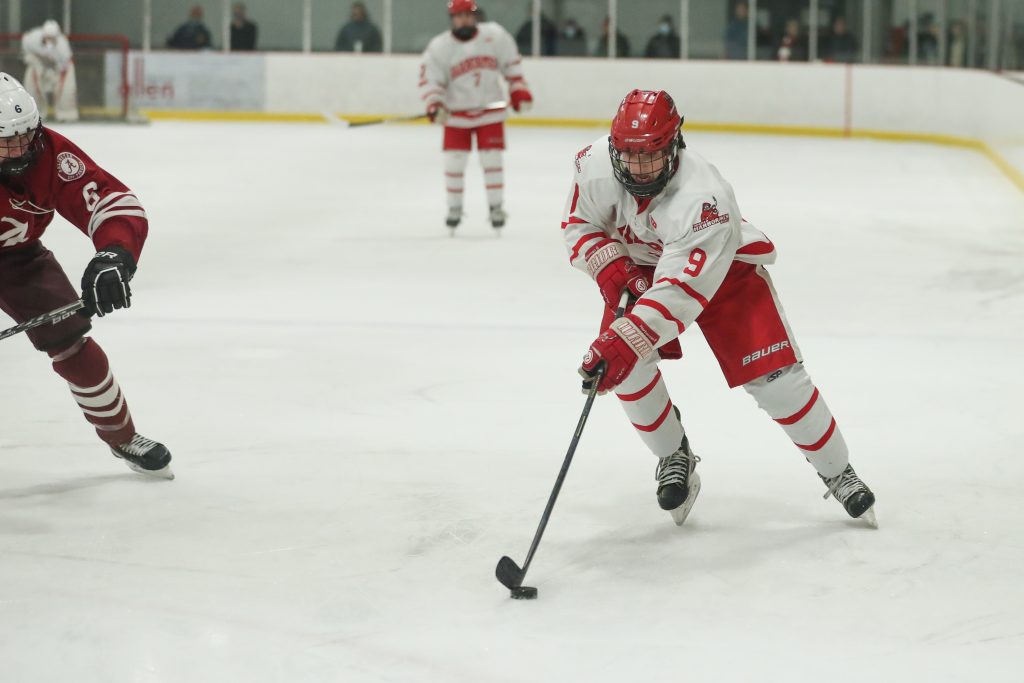 Senior captain Sean Garrity brings the puck over the blue line before taking a shot. 