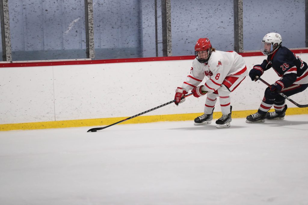 Senior Connor Walsh brings the puck behind the Central Catholic net late in the game. 