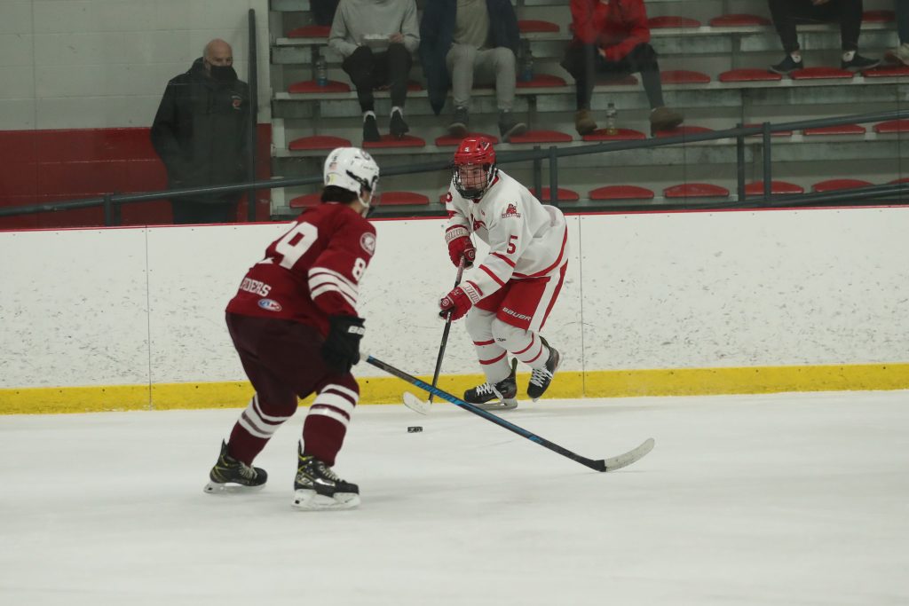Senior Ryan Burns carries the puck into the Arlington zone looking for a teammate. 