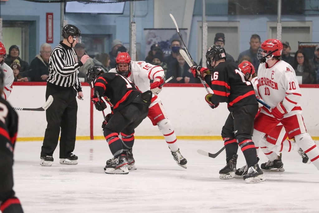 Senior Wyatt Iaria trying to get possession of the puck during a face-off. 