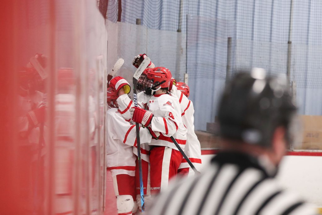 Teammates smother junior Chase McKenna after his go ahead goal. 