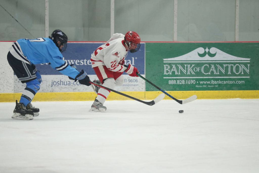 Junior Connor Richardson cirlces around the boards in the first period. 