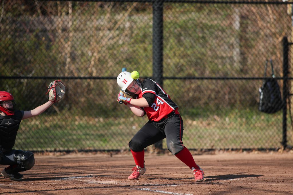 Junior Sarah Holler takes a ball off the helmet in the first inning. 