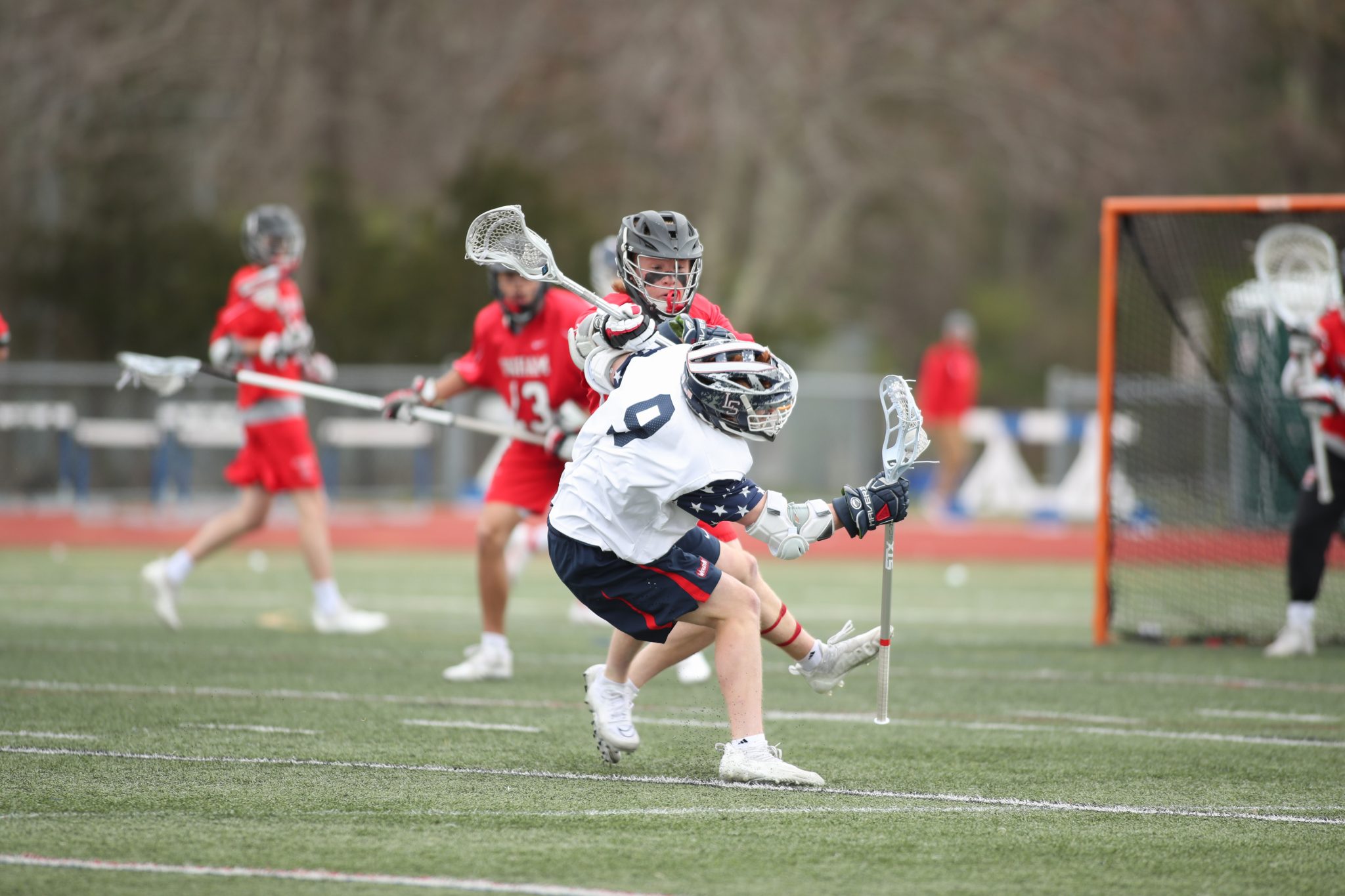 Senior Connor Walsh checks a Lincoln-Sudbury player early in the physical, hard-fought loss on Saturday.