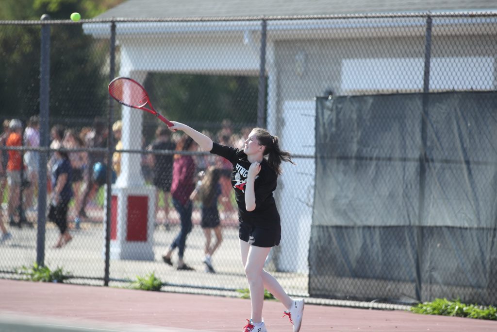 Catelyn Arnold serves the ball in her doubles match.