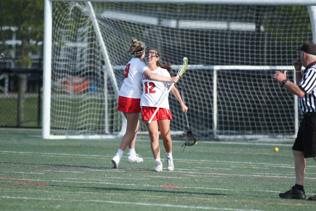 Senior Alexa Varholak is hugged by freshman Caroline Connelly after scoring her first goal of the season. 