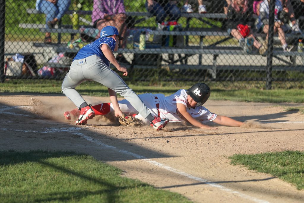 Kian Thayer slides safely into home against Braintree East.