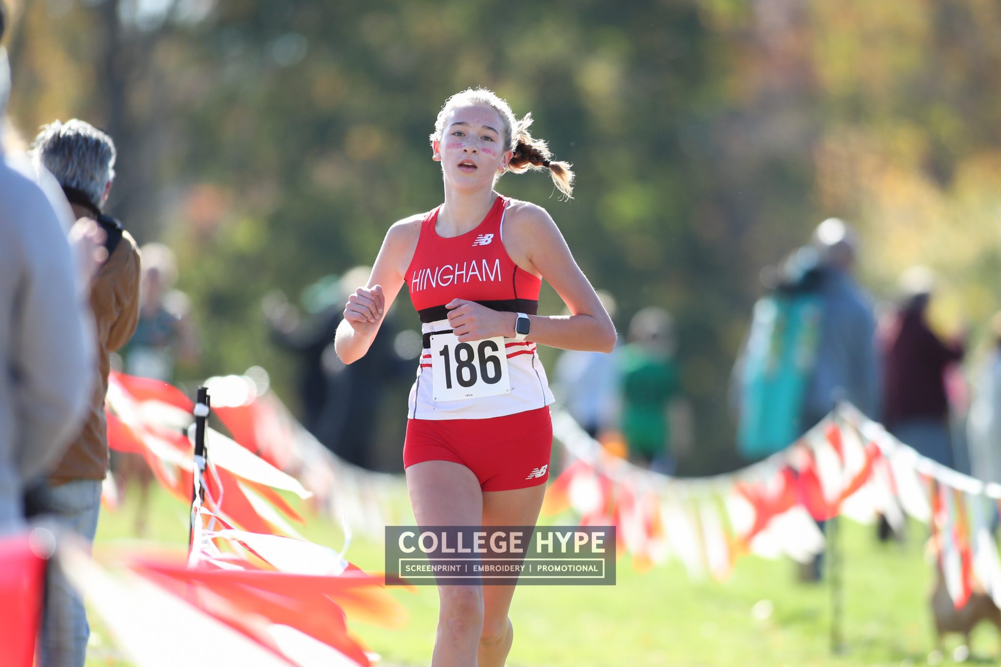 Sophomore Clare Lowther runs down the back stretch of the Patriot League Championship course held in Hingham on Saturday.