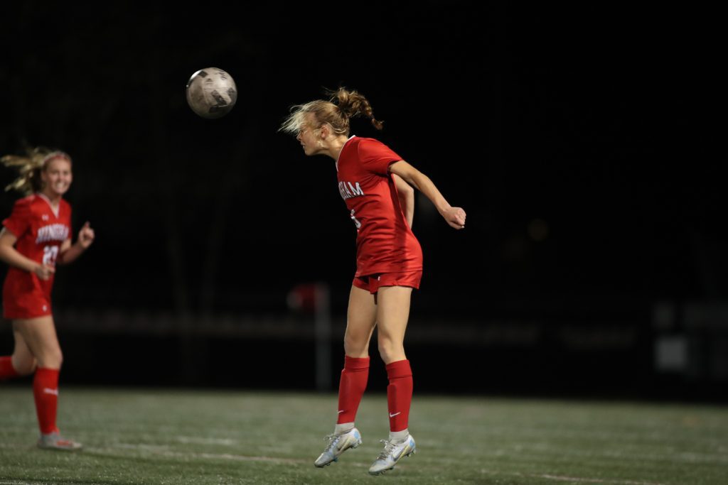 Sophomore Grace Maroney uses her head to clear the ball. 
