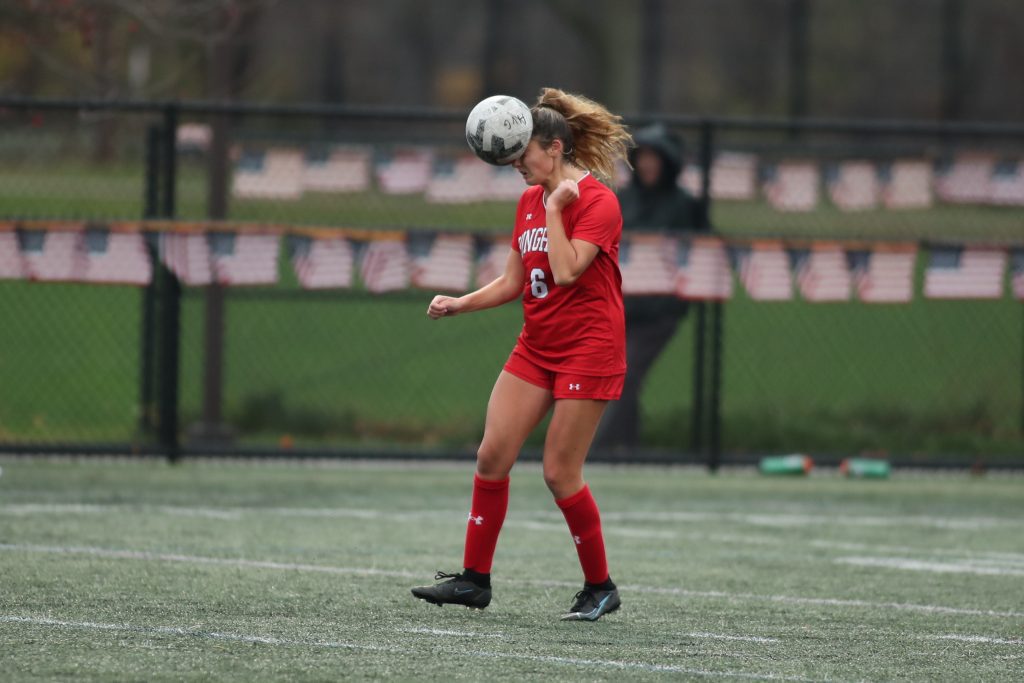 Senior captain Maddie Aughe using her head to get the ball out of Hingham's end of the field. 
