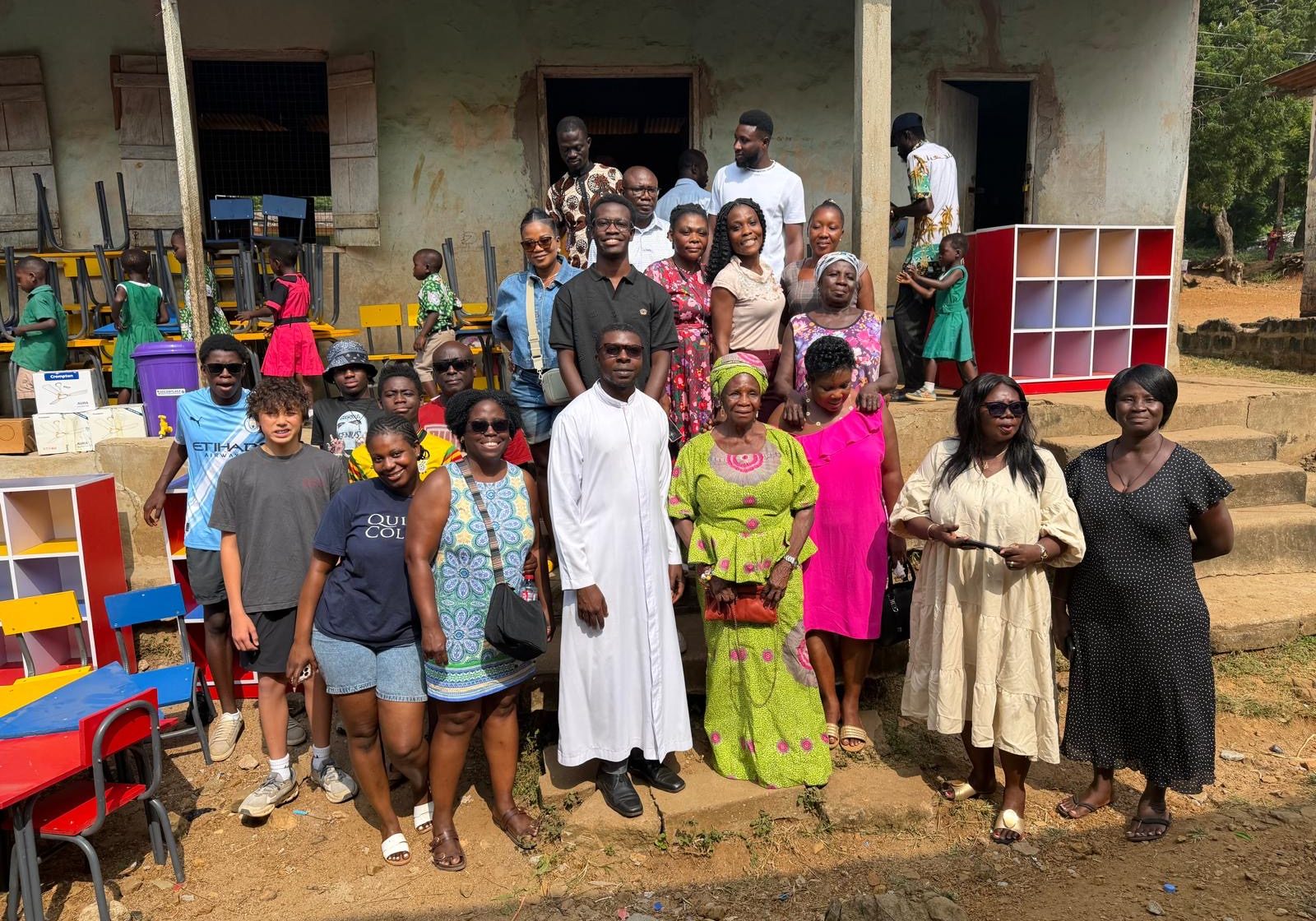 Kwaku Oppong (pictured in the center) with students and faculty from Roman Catholic Primary School in Mumford, Ghana