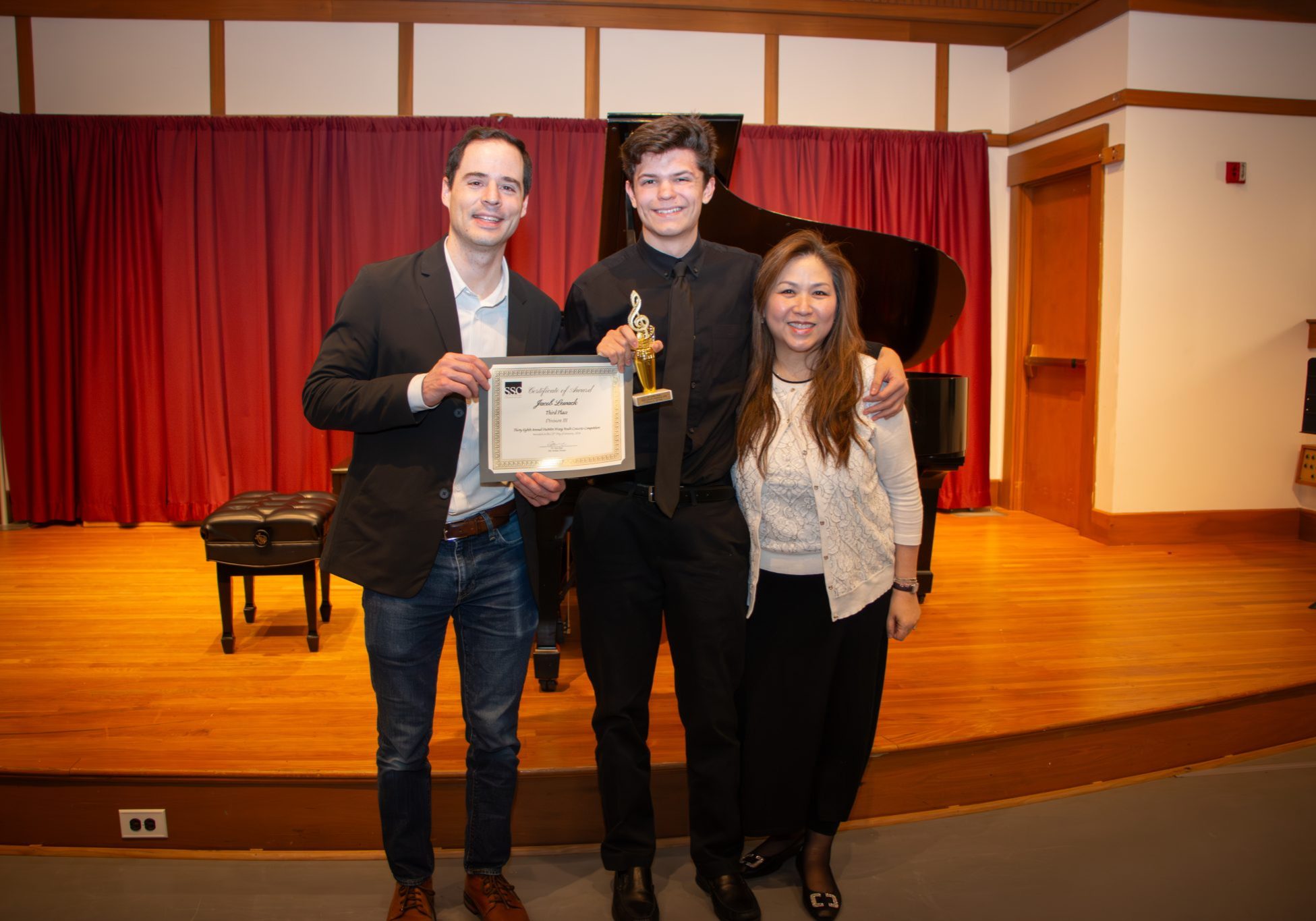 Jacob Lewack of Hingham poses with SSC Artistic Director Steve Bass and SSC teaching artist HuiMin Wang