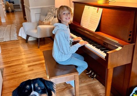 SSC piano student Freddy Frymire plays for his dog Brutus