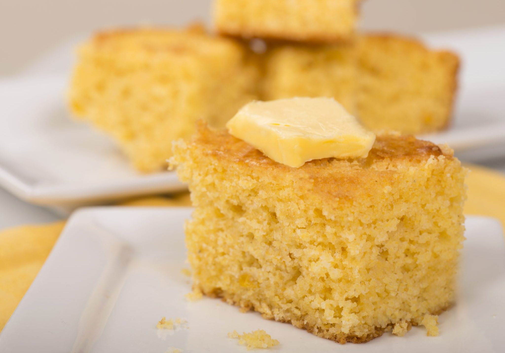 Freshly baked cornbread with creamy butter on top